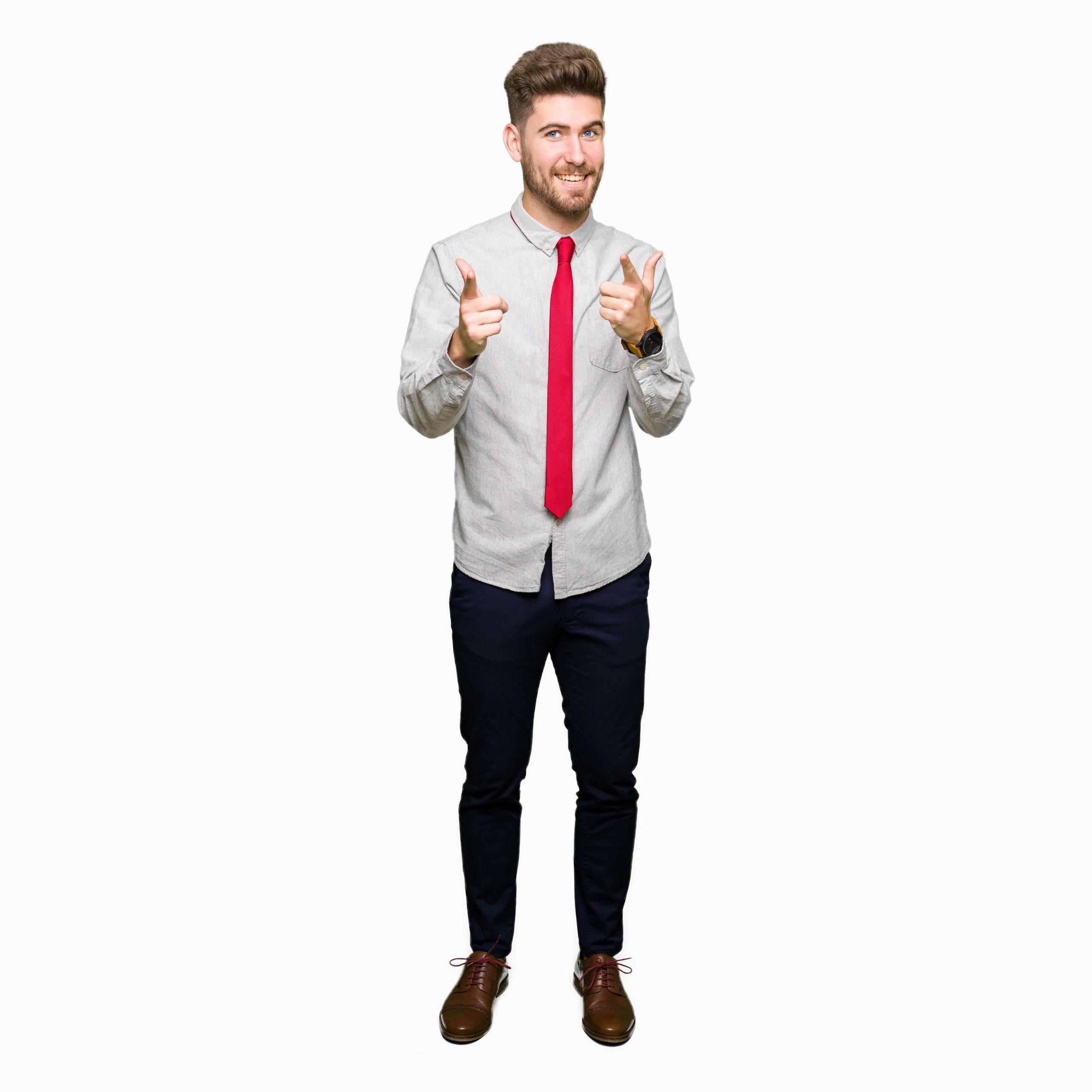 Young handsome business man pointing fingers to camera with happy and funny face. Good energy and vibes.