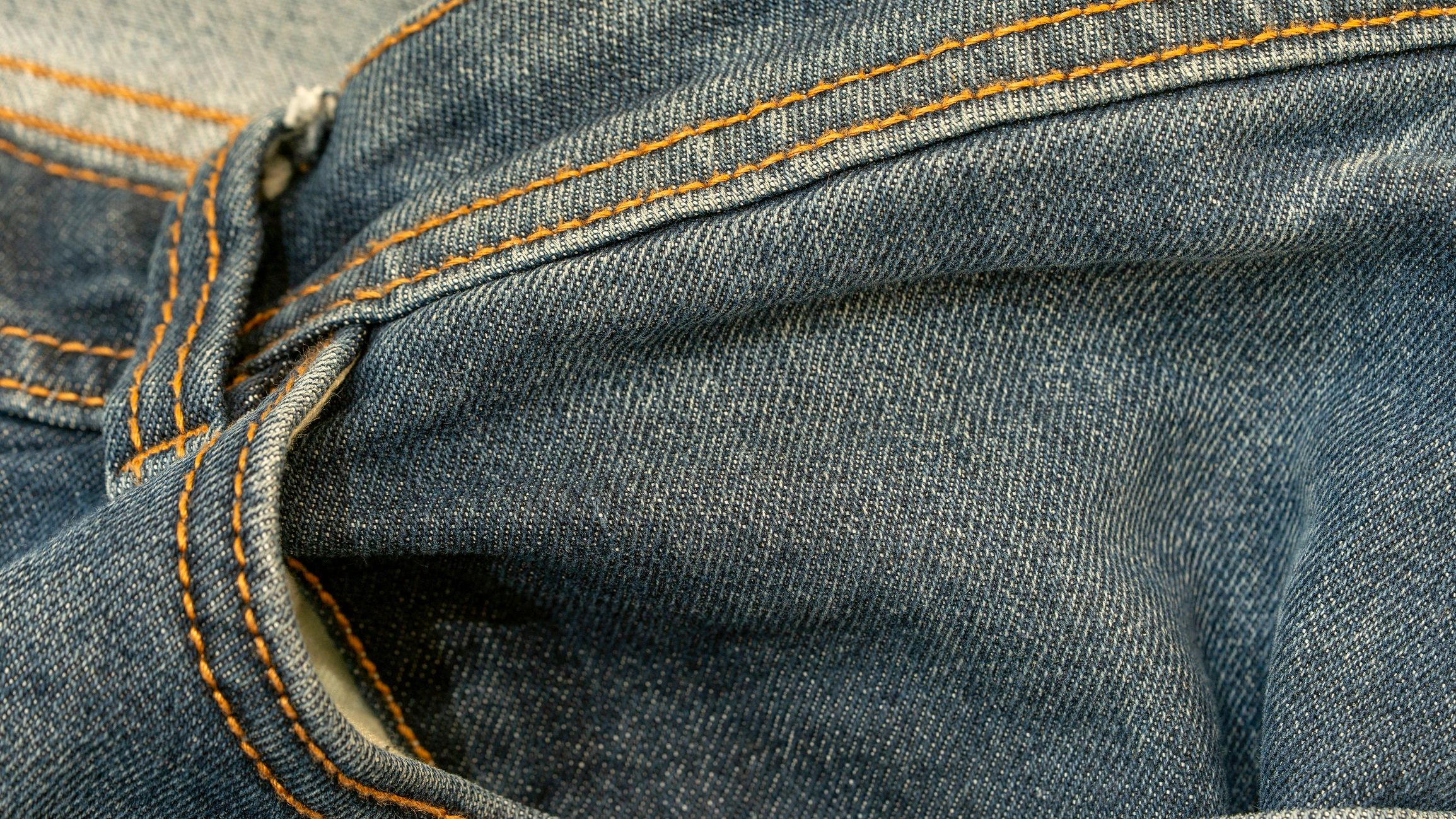 Detailed view of classic blue jeans pocket and texture